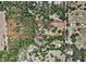 Sprawling lot with lush trees, surrounded by greenery, as shown in this aerial view at 5870 Jim Davis Rd, Parrish, FL 34219