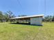 Open barn structure surrounded by lush greenery, ideal for storage or agricultural use at 5870 Jim Davis Rd, Parrish, FL 34219