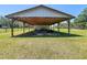 Well-maintained barn featuring sturdy wooden supports, offering ample space and potential at 5870 Jim Davis Rd, Parrish, FL 34219