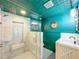 Bathroom with a marble-tiled walk-in shower, white vanity sink, and an accent wall at 5870 Jim Davis Rd, Parrish, FL 34219