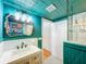 Bathroom with white vanity sink, accent walls, a detailed mirror, and marble-tiled walk-in shower at 5870 Jim Davis Rd, Parrish, FL 34219