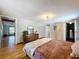 Bedroom features wood floors, a closet, and an ensuite bathroom at 5870 Jim Davis Rd, Parrish, FL 34219