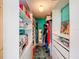 A well-organized walk-in closet boasts ample storage space and colorful accents at 5870 Jim Davis Rd, Parrish, FL 34219