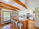 Bright kitchen boasts a wood breakfast bar, white cabinets, stainless appliances, and lovely views of the outdoor landscape at 5870 Jim Davis Rd, Parrish, FL 34219