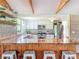 Well-appointed kitchen with long wood countertops, designer backsplash, stainless appliances, and breakfast bar with seating at 5870 Jim Davis Rd, Parrish, FL 34219