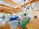 The open-concept living room features high ceilings, hardwood floors, and many windows at 5870 Jim Davis Rd, Parrish, FL 34219