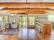 Spacious living and dining area with lots of natural light, exposed beams, and beautiful hardwood flooring at 5870 Jim Davis Rd, Parrish, FL 34219