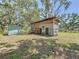 Two weathered sheds surrounded by trees, offering outdoor storage solutions at 5870 Jim Davis Rd, Parrish, FL 34219