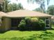 Well-maintained backyard with a screened-in porch and green shrubs at 6130 Whimbrelwood Dr, Lithia, FL 33547