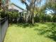 Large backyard featuring well-maintained lawn and a black metal fence at 6130 Whimbrelwood Dr, Lithia, FL 33547
