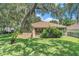 Large backyard with healthy grass and a screened in patio at 6130 Whimbrelwood Dr, Lithia, FL 33547