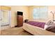 Bedroom with a queen size bed, dresser and natural light coming through the window at 6130 Whimbrelwood Dr, Lithia, FL 33547