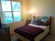 Bedroom with a red and black blanket, and a window providing ample light at 6130 Whimbrelwood Dr, Lithia, FL 33547