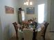 Dining area featuring a table with chairs, decorative accents, and bright natural light at 6130 Whimbrelwood Dr, Lithia, FL 33547