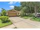 Charming home featuring well-maintained lawn, landscaping and spacious driveway at 6130 Whimbrelwood Dr, Lithia, FL 33547