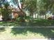 Beautiful, well-manicured front lawn of home with various trees and plants at 6130 Whimbrelwood Dr, Lithia, FL 33547
