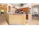 The kitchen features custom cabinets and a breakfast bar overlooking the dining area at 6130 Whimbrelwood Dr, Lithia, FL 33547