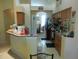 Traditional-style kitchen with breakfast bar and view into the dining area at 6130 Whimbrelwood Dr, Lithia, FL 33547