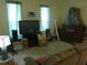 Living room decorated with a television, artwork, and comfortable seating at 6130 Whimbrelwood Dr, Lithia, FL 33547