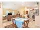 View of the living room with dining table featuring tile flooring and natural light at 6130 Whimbrelwood Dr, Lithia, FL 33547