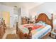 Main bedroom with a decorative wood bed, dresser, closet and a view to the main bath at 6130 Whimbrelwood Dr, Lithia, FL 33547
