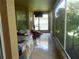 Enclosed patio featuring tile floors, furniture, and natural light at 6130 Whimbrelwood Dr, Lithia, FL 33547