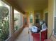 Enclosed patio with tile flooring and lots of natural light from the surrounding yard at 6130 Whimbrelwood Dr, Lithia, FL 33547