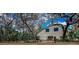 A fenced backyard offering privacy and security, surrounded by trees and natural landscaping at 6230 Gannetdale Dr, Lithia, FL 33547