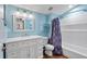 Bright bathroom featuring modern vanity, commode, shower-tub, and light blue walls at 6230 Gannetdale Dr, Lithia, FL 33547