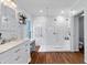 Luxurious bathroom with a glass-enclosed shower, double showerheads, and marble countertops at 6230 Gannetdale Dr, Lithia, FL 33547