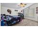 Bedroom with ceiling fan, natural light, and dark accent wall at 6230 Gannetdale Dr, Lithia, FL 33547