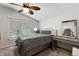 Bedroom features a large window, neutral tones, and a minimalist design at 6230 Gannetdale Dr, Lithia, FL 33547