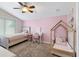 Bedroom featuring pink walls, carpeted floor, and window, showcasing a cozy atmosphere at 6230 Gannetdale Dr, Lithia, FL 33547