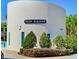Community clubhouse with lush landscaping featuring palm trees, bushes, and greenery at 6230 Gannetdale Dr, Lithia, FL 33547