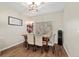 Formal dining area features hardwood floors, a contemporary light fixture, and a large window at 6230 Gannetdale Dr, Lithia, FL 33547