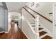 Bright entryway featuring wood floors, staircase with wood railing, and natural light at 6230 Gannetdale Dr, Lithia, FL 33547