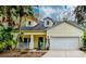 Inviting single-Gathering home with a cozy porch, neat landscaping, and a convenient two-car garage at 6230 Gannetdale Dr, Lithia, FL 33547