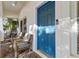Charming front porch featuring a vibrant blue door, seating, and stylish decor, creating a welcoming entrance at 6230 Gannetdale Dr, Lithia, FL 33547