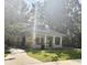 Community gazebo with stone accents, concrete flooring, and mature trees at 6230 Gannetdale Dr, Lithia, FL 33547