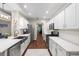 Modern kitchen with stainless steel appliances, ample counter space, and a view into the dining area at 6230 Gannetdale Dr, Lithia, FL 33547