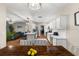 Open kitchen and dining area featuring wood floors, modern appliances, and plenty of natural light at 6230 Gannetdale Dr, Lithia, FL 33547