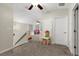 Cozy upstairs loft area with soft carpet, neutral colors, and plenty of natural light at 6230 Gannetdale Dr, Lithia, FL 33547