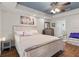 Spacious bedroom with wood floors, a tray ceiling with a fan, and soft, neutral decor at 6230 Gannetdale Dr, Lithia, FL 33547