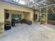 Screened patio with comfortable seating area and grill at 6230 Gannetdale Dr, Lithia, FL 33547