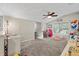 Spacious playroom with neutral carpet, ceiling fan, window, and ample natural light at 6230 Gannetdale Dr, Lithia, FL 33547