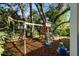Fun backyard playground for with swings, slide, and playhouse, perfect for outdoor activities and entertainment at 6230 Gannetdale Dr, Lithia, FL 33547