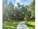 Community playground and green space with mature trees, and concrete path at 6230 Gannetdale Dr, Lithia, FL 33547