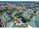 Stunning aerial view of waterfront condos with lush landscaping and a sparkling community pool at 6451 Sunset Bay Cir, Apollo Beach, FL 33572
