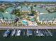 Aerial view of the townhome community featuring boat docks, a pool, and lush landscaping at 6451 Sunset Bay Cir, Apollo Beach, FL 33572