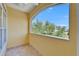 A well-lit balcony with yellow walls and a view of the community at 6451 Sunset Bay Cir, Apollo Beach, FL 33572